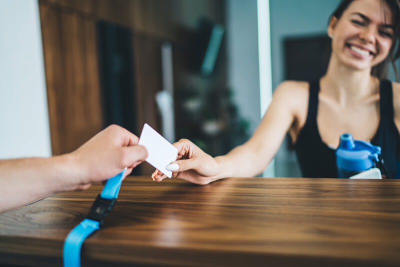 Women using a access card for gym entrance