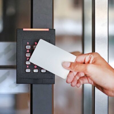 Door access control - young person holding a key card to lock and unlock door importance of access control